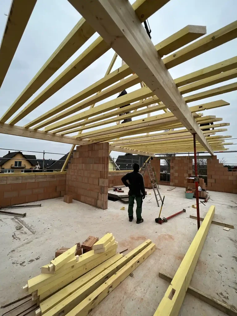 Vue chantier maison neuve : gros œuvre, charpente bois et couverture tuiles à Mommenheim.